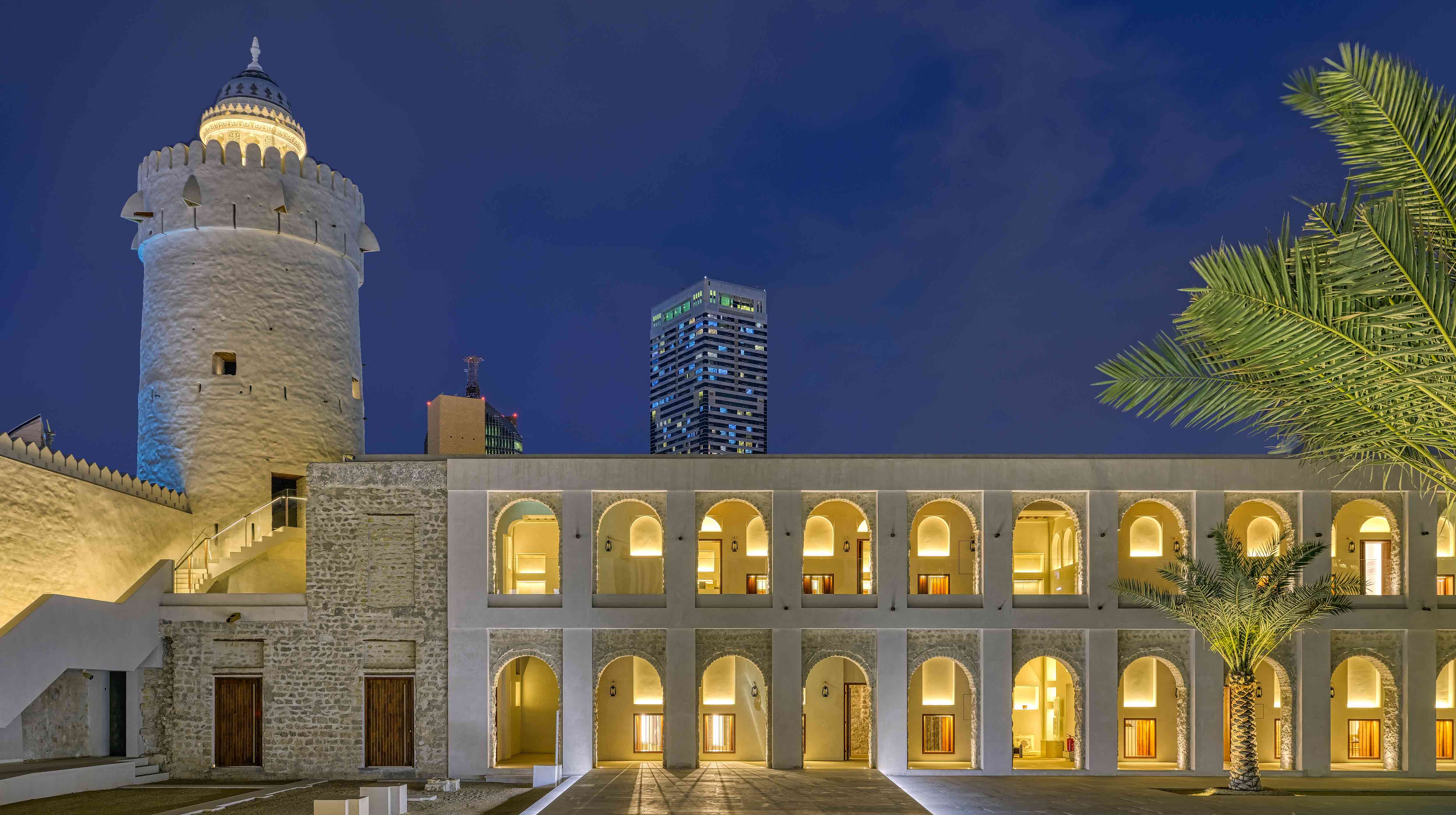 White building with openings made of small arches in Qasr Al Hosn